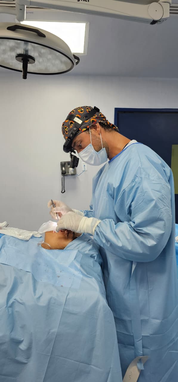 Dr. Jorge Barbachano operating at Hospital Galenia with a surgical headlight