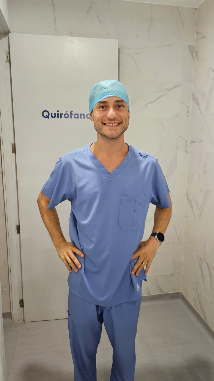 Dr. Jorge Barbachano Torres smiling in scrubs outside the operating room